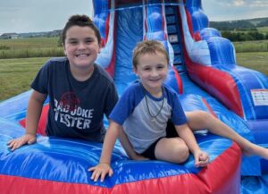 Kids smiling on water slide