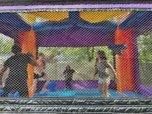 Kids playing in bounce house during field day