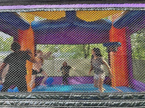 Kids playing in bounce house during field day